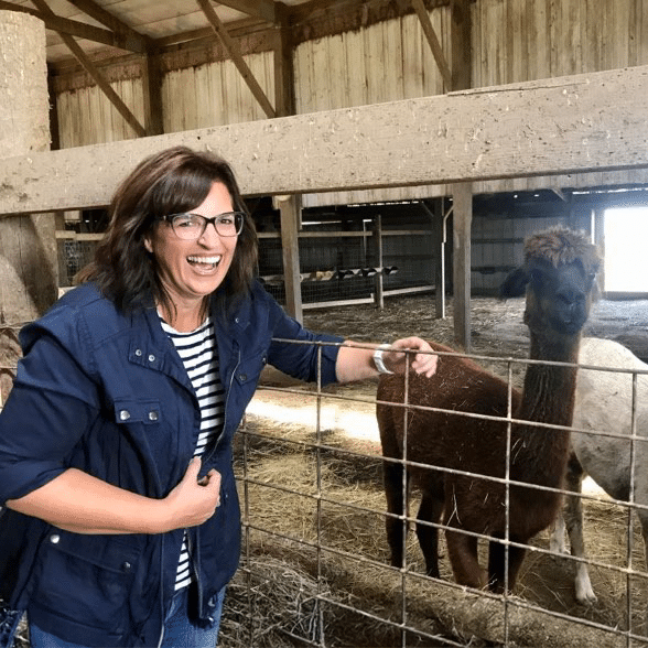 women with a lama in a farm